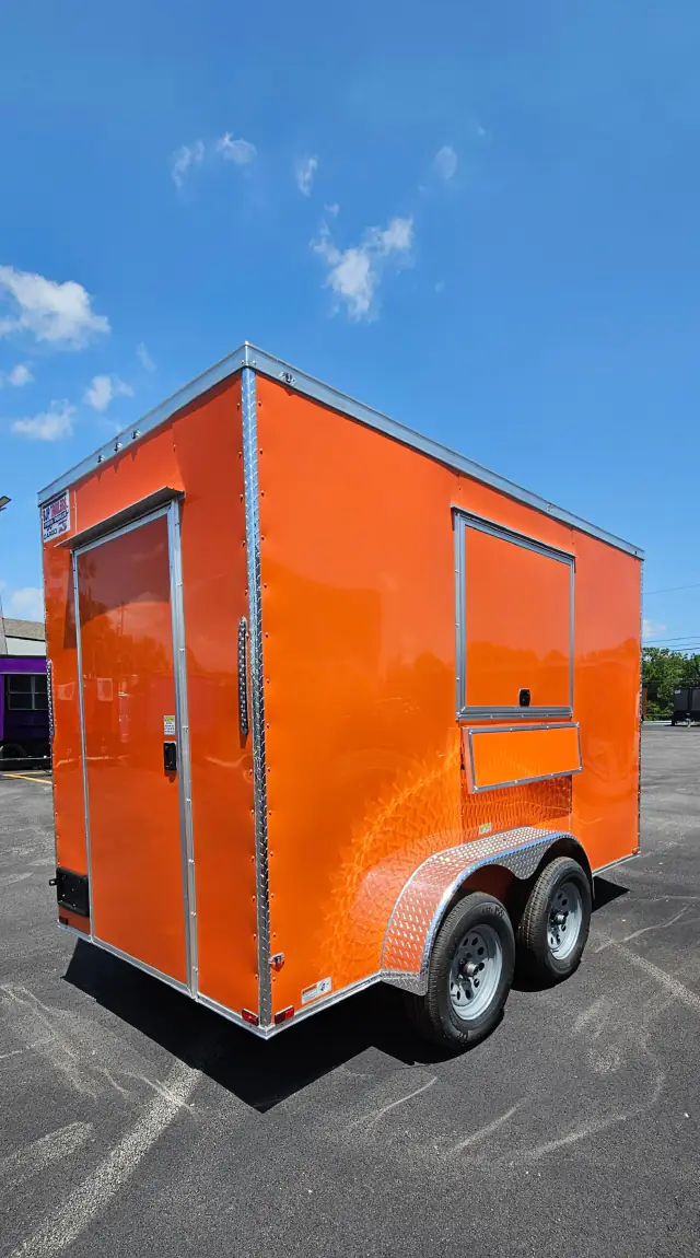 Orange 6 by 12 BJP concession trailer with a service window